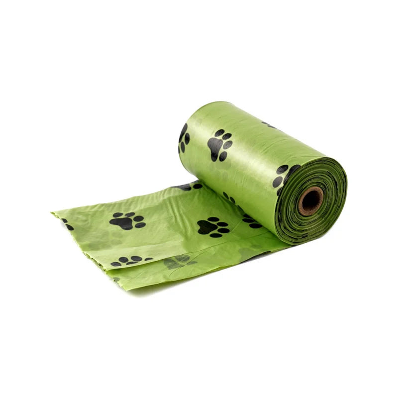 Unrolled green dog poop bag with black paw prints